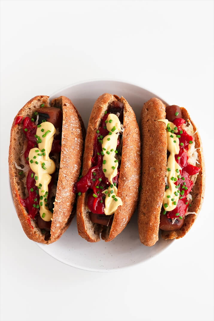 Carrot hot dogs in whole wheat buns with condiments.