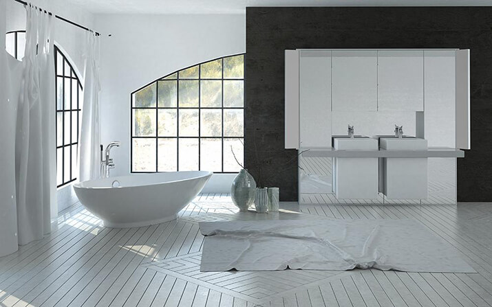 Black window frames stand out from this spacious bathroom with white wood flooring.