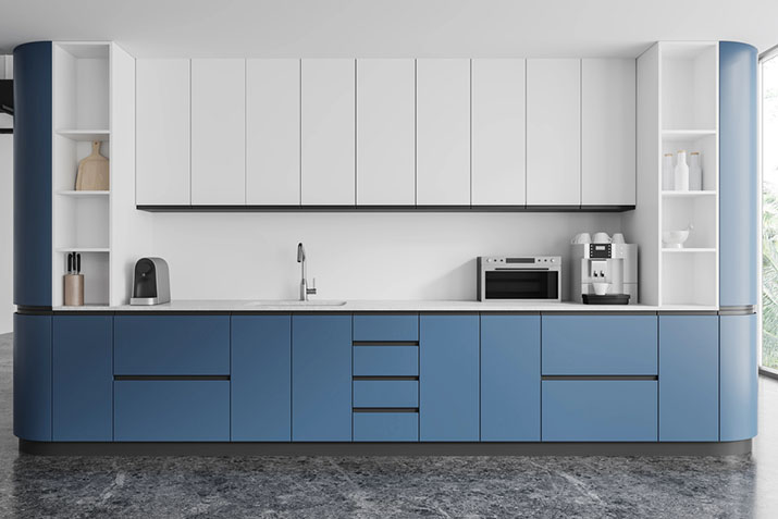 Blue kitchen cabinets with standard toe kick height recessed at the base.