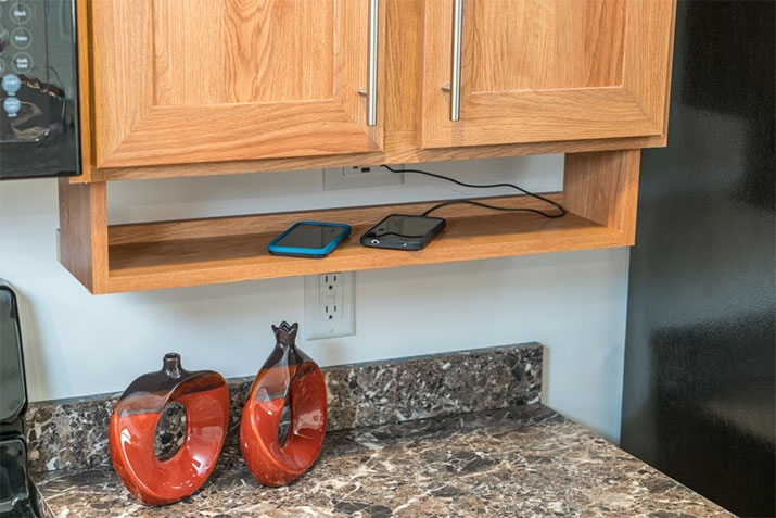 Built-in under-cabinet storage for phone while charging.
