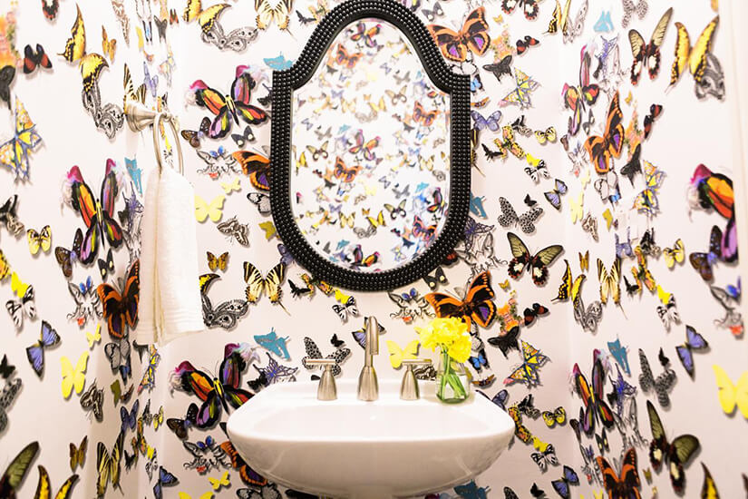 This bold wallpaper covers the bathroom in butterflies and makes a statement.