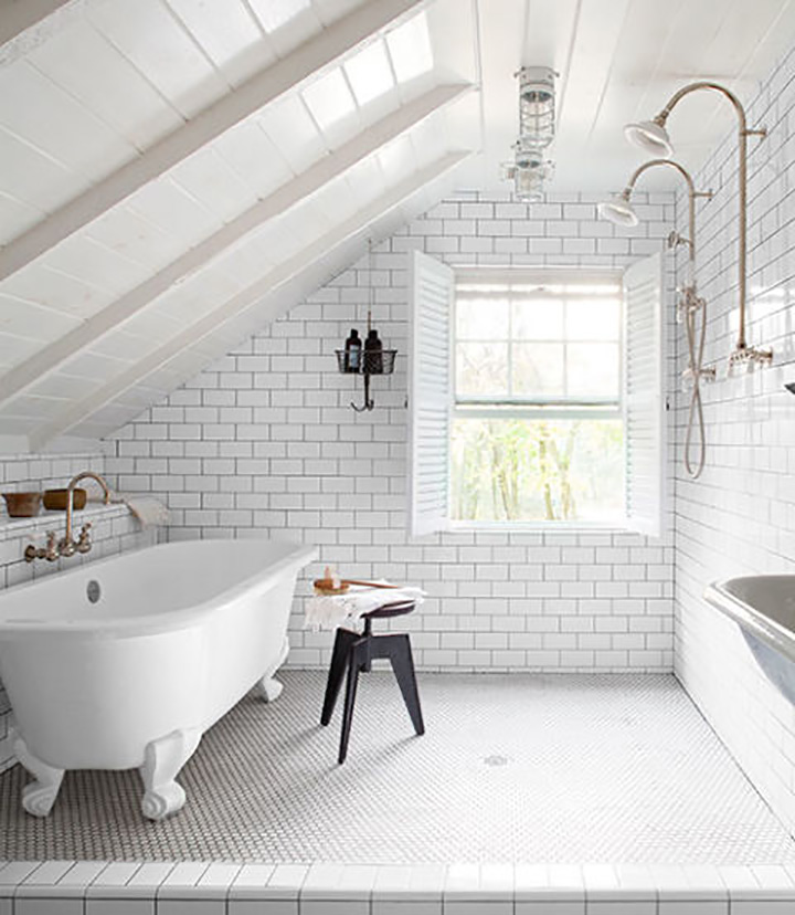 Classic white clawfoot tub, white tile walls and flooring, black stool