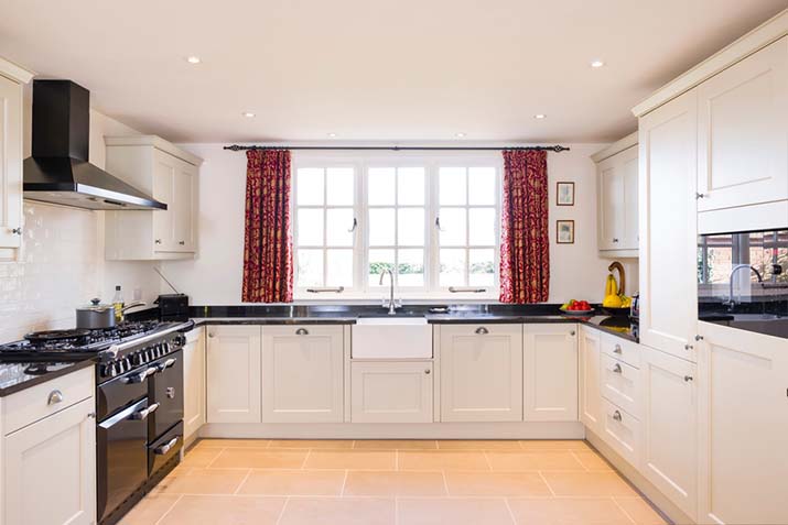 White cabinets in a small kitchen with natural light.