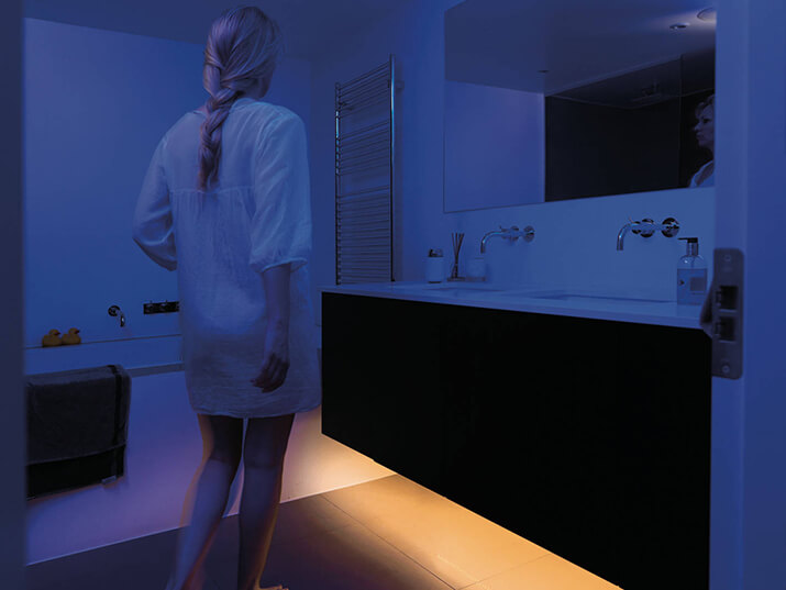 Contemporary bathroom remodel with built-in undermount night light.