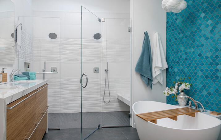 Contemporary master blue tile gray floor bathroom and textured white shower surround.