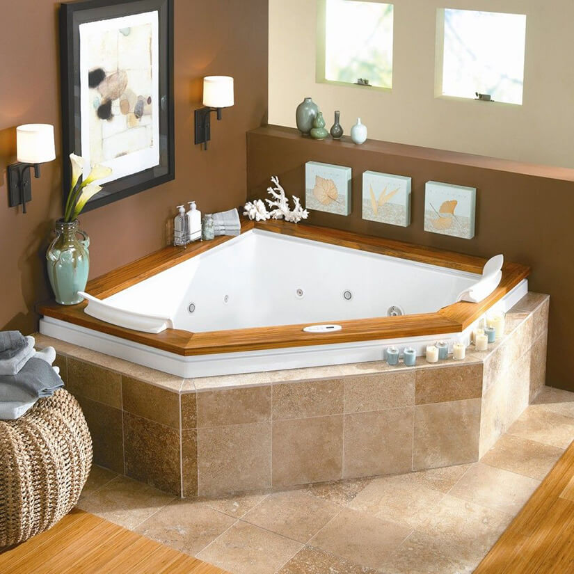 Corner bathtub style with jets surrounded by stone tile.