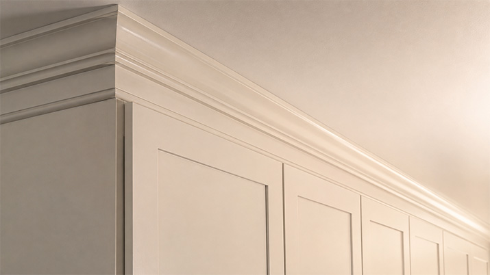 Crown molding closing the gap between kitchen cabinets and the ceiling.
