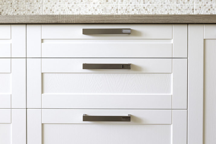 Crisp white cabinets with edge pulls.