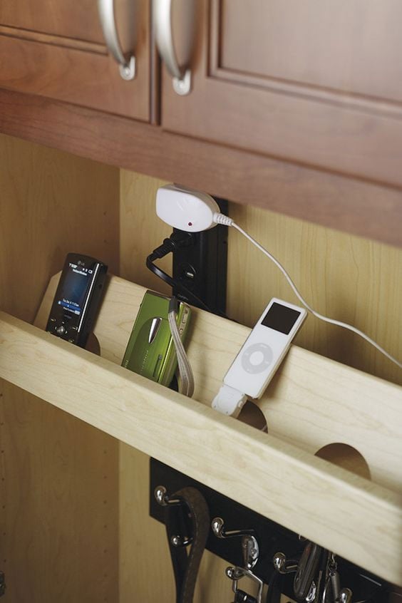 Floating shelf under kitchen cabinet to hold charging devices.