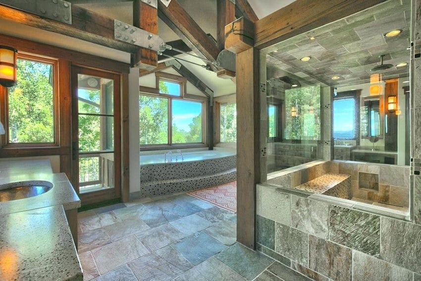 Glamorous bathroom with exposed beams and stone tiles.