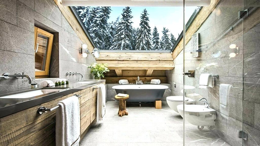 Huge skylight showcasing the snowy treetops makes this bathroom glamorous.