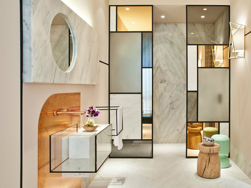 Glamorous bathroom with modernist styling, bright light, and angular fixtures.
