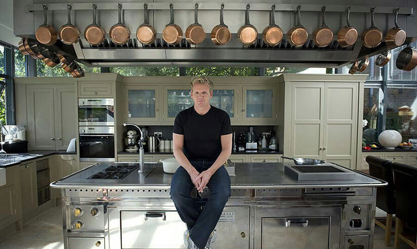 Gordon Ramsay sitting on his Rorgue cooker, the centerpiece of his five-star home kitchen.