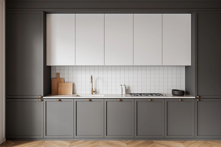 Gray kitchen showing adjustable toe kick height options on lower cabinets.