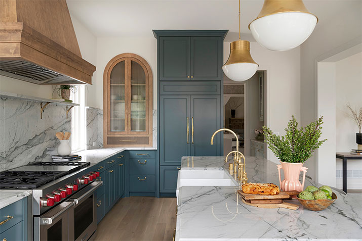 Kitchen with blue cabinets and natural wood elements.