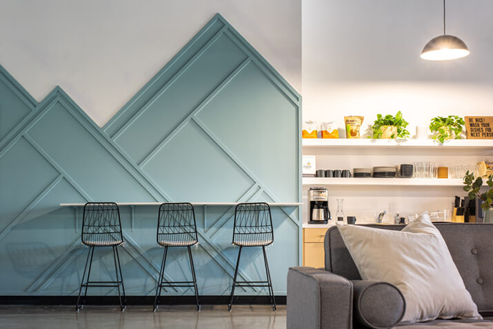 Kitchen dining area featuring a blue board and batten accent wall.
