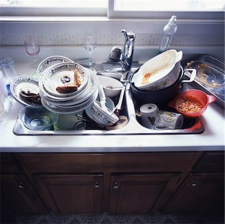 A pot with an egg is buried somewhere in this large pile of dishes.