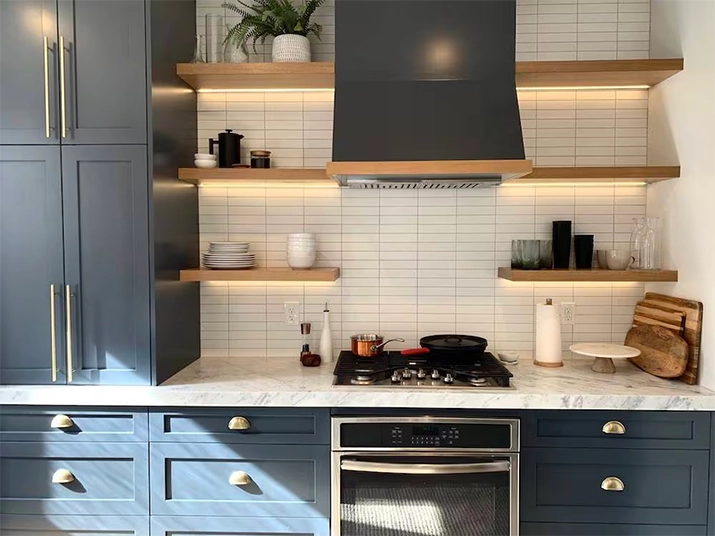 Kitchen with natural wood open shelving with LED strip lighting.