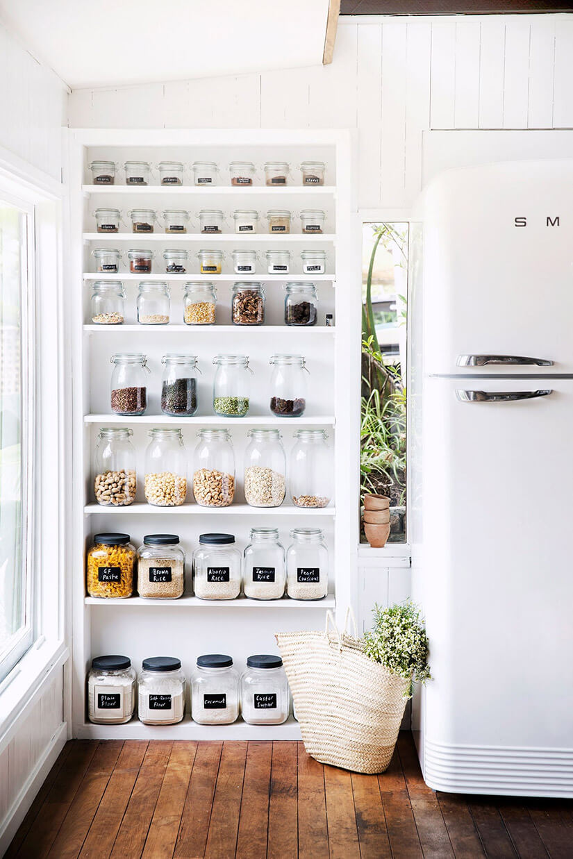 In this refrigerator kitchen storage zone, dry goods are organized in jars within easy reach.