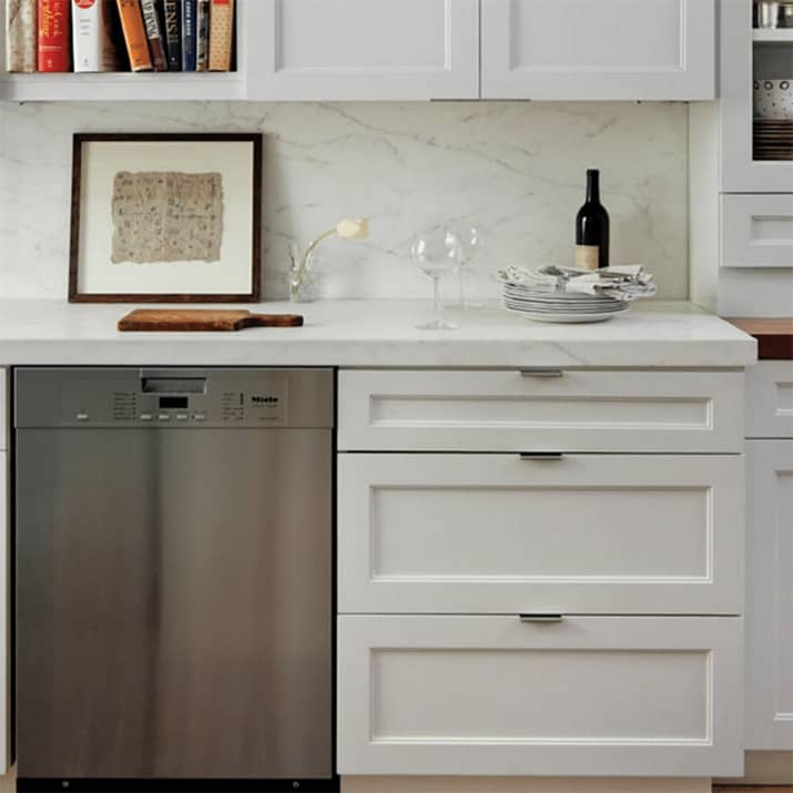 Kitchen with white shaker cabinets and minimalistic edge pulls.