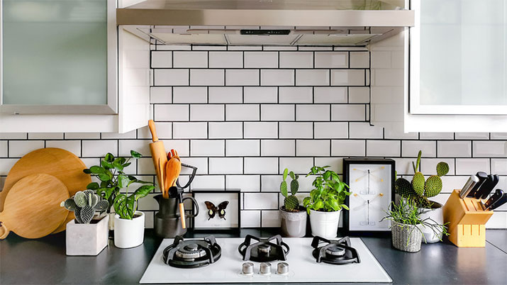 Kitchen with white subway tile and dark gray grout.