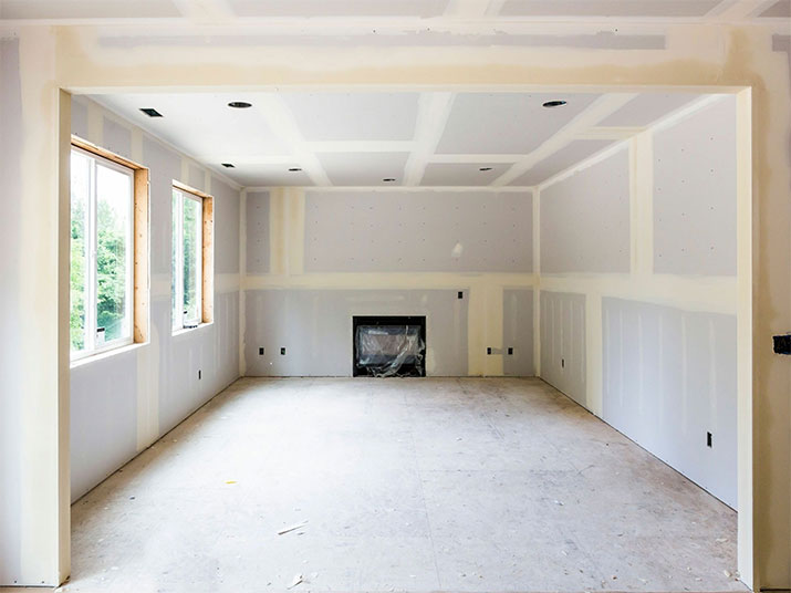 Living room with newly installed drywall panels.