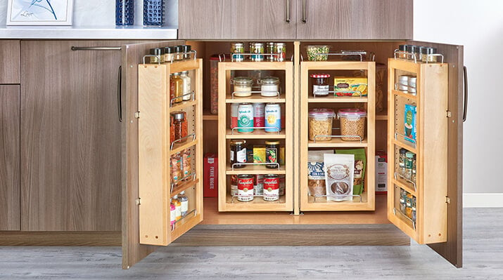 Here is a low cabinet pantry with added shelves on the doors fully stocked with food. There are also roll out shelves to provide more functionality to the depth of the cabinet.