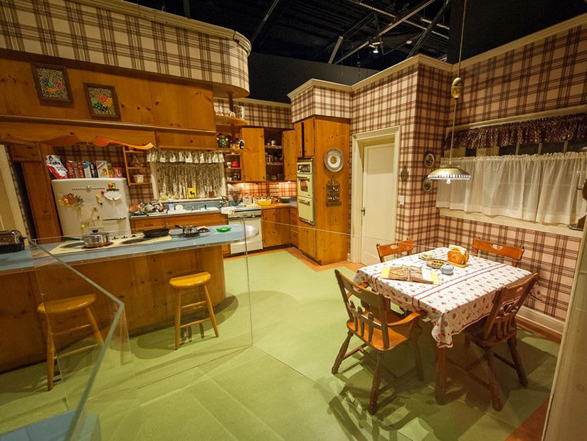 Mad Men's TV show kitchen is a faithful representation of a suburban 60's kitchen with plaid wallpaper and chartreuse flooring.