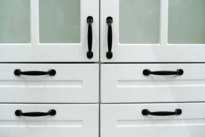 Matte black hardware on white cabinets.