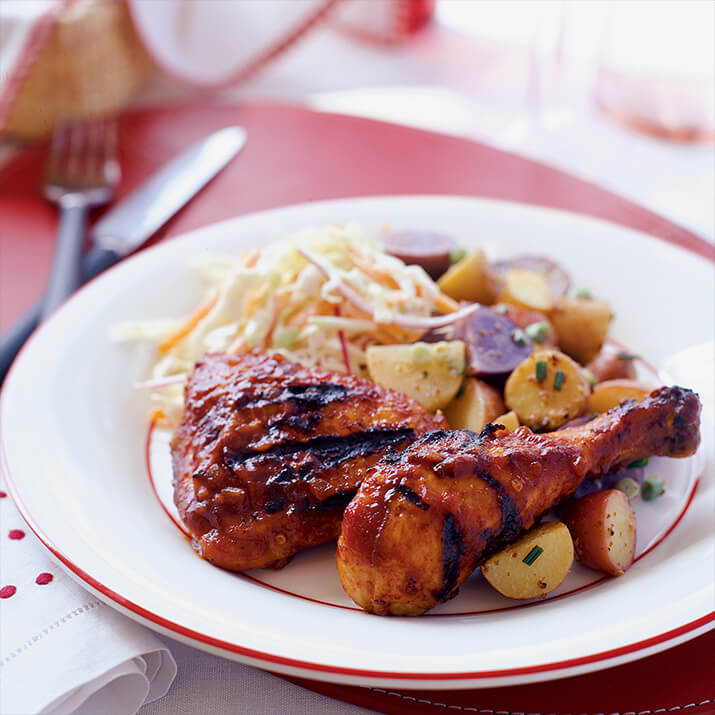 Southern-style barbecue chicken paired with potatoes and coleslaw.