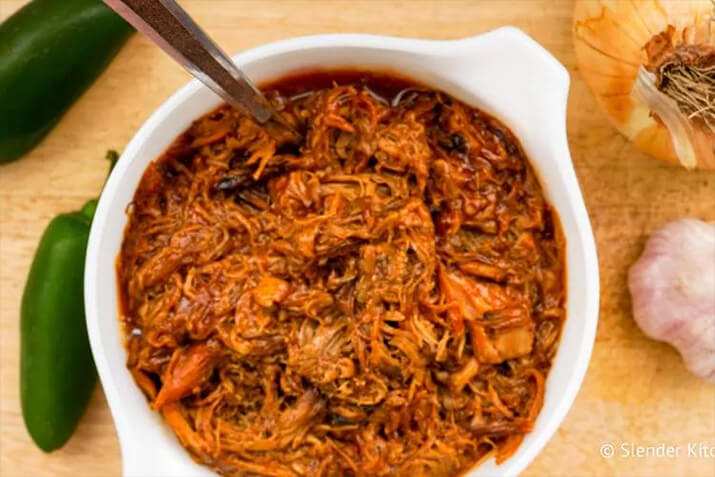 Spicy barbecue slow cooker pulled pork with jalapenos, garlic, and onions.