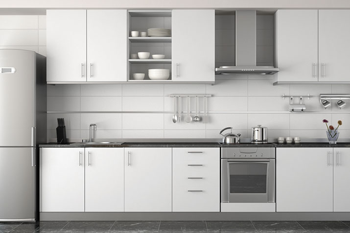 Variety of metal finishes on white cabinets in modern kitchen.