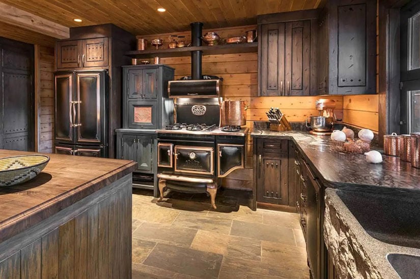 Copper accents raw wood in this rustic kitchen.