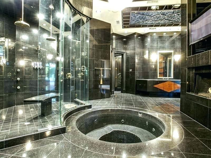 Modern glamorous bathroom covered in stone tiles and glass.
