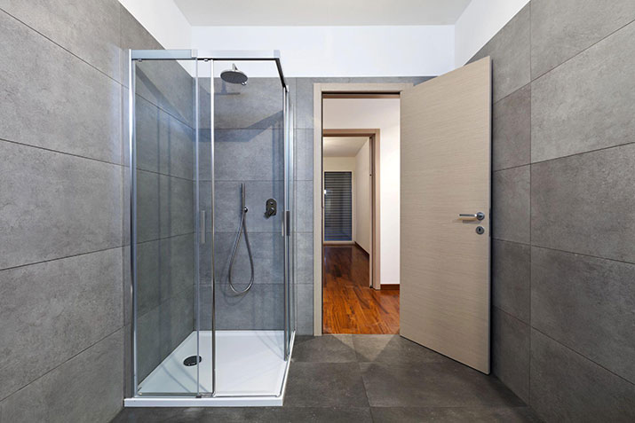 A modern shower with a glass door.