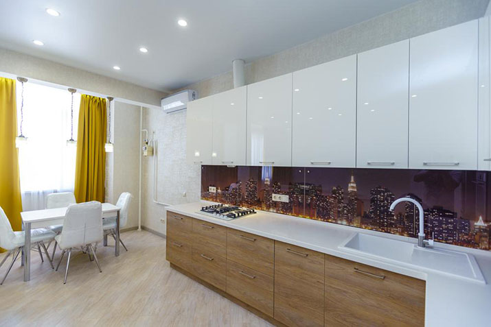 Modern kitchen with decorative toe kick area and under-cabinet lighting.