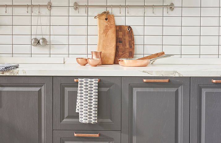 Gorgeous gray kitchen cabinets with bronze hardware.