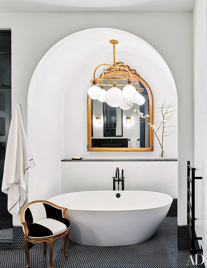 Naomi Watts: Free standing white tub under archway with gold trims