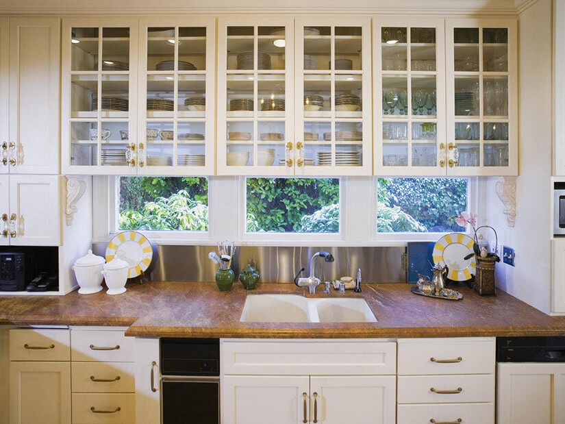 Open cabinets by the sink store plates and bowls making cleanup easy.