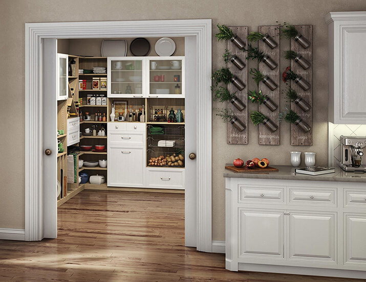 These are open double doors of a walk-in pantry with storage for food and kitchen equipment. The flooring of the pantry connects to the kitchen.