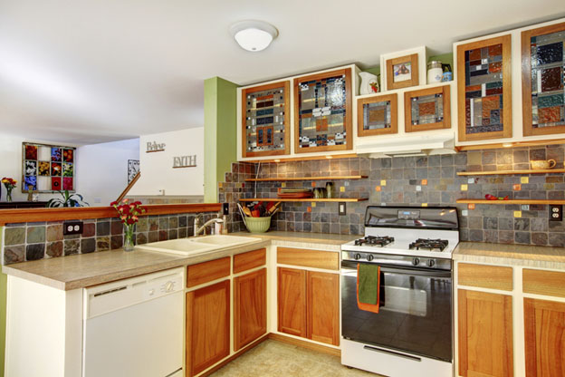 Eclectic kitchen with multicolored cabinets.