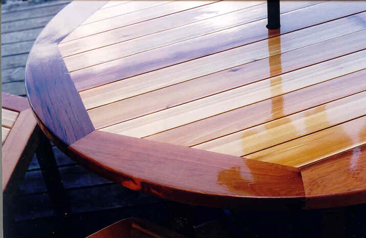 Outdoor table and chairs with a top coat of glossy varnish.