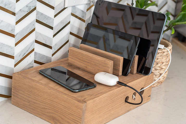 Portable wooden charging station for mobile devices.