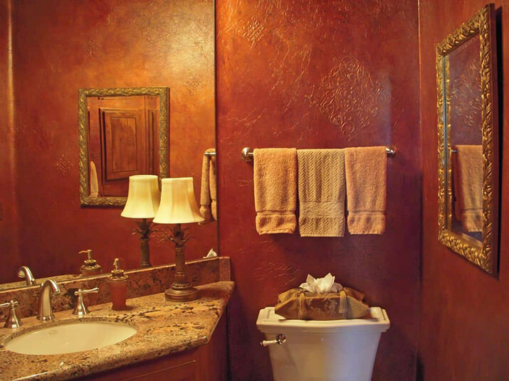 tan bathroom with red accents