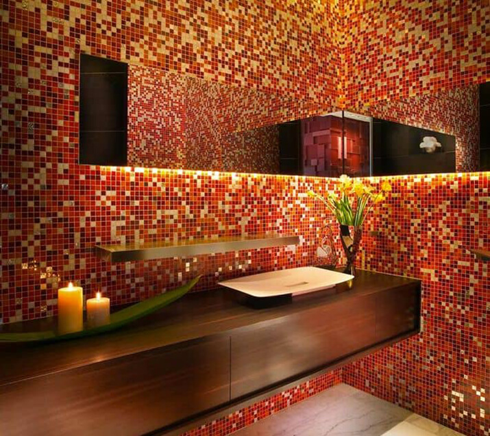Small tiles create a striking pattern in this red bathroom with gentle lighting.
