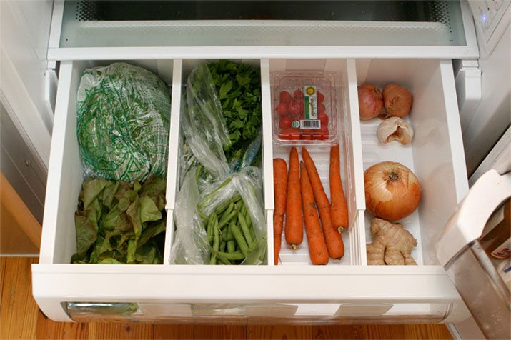Refrigerator drawers with dividers to organize produce.