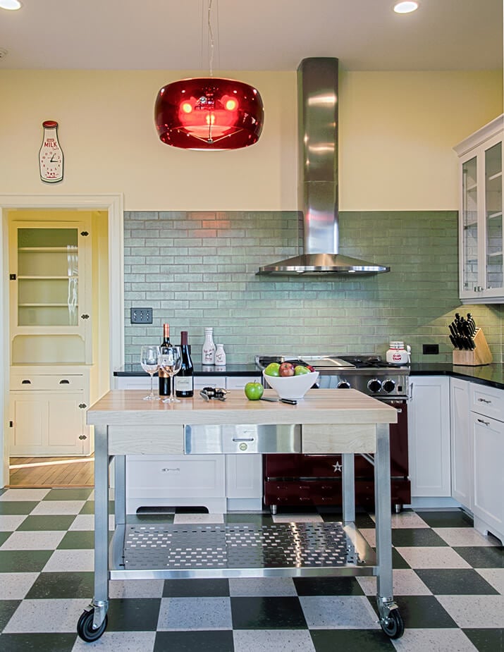Retro-inspired mid-century modern kitchen with checkered flooring and chrome details.
