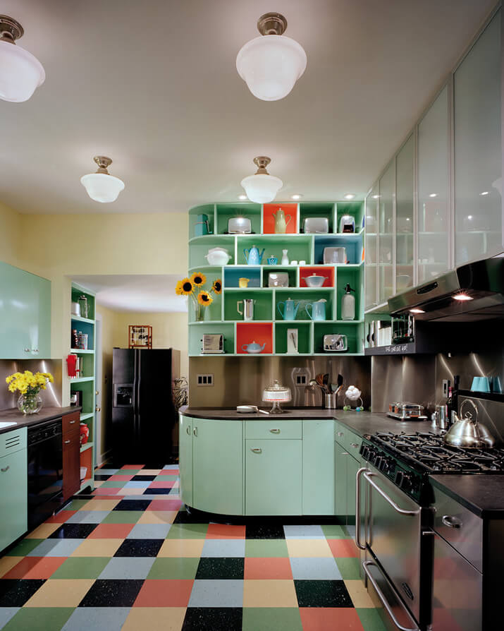 Retro kitchen with vibrant colors and openly displayed kitchenware.