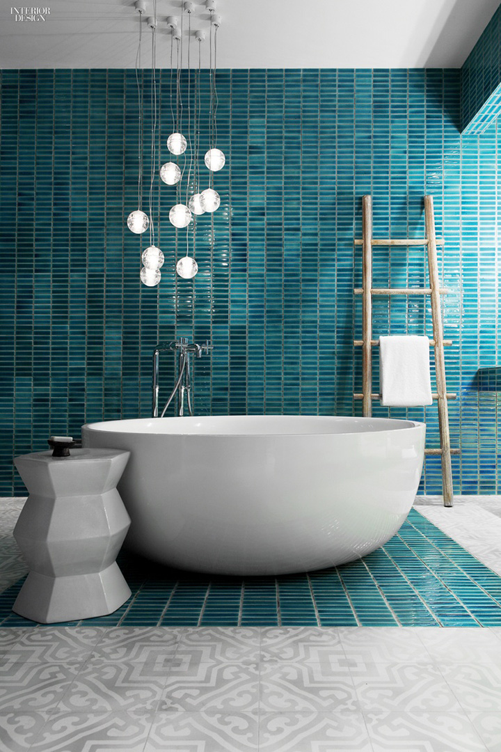 Round white bowl tub, teal tiles, wooden towel stand