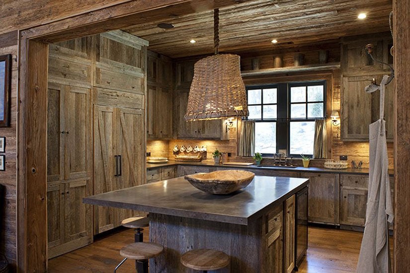 This rustic kitchen design features an aged barn wood aesthetic throughout.